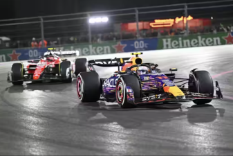 An image of Sergio Perez of Oracle Red Bull Racing, right, and Charles Leclerc of the Scuderia Ferrari team compete in the Las Vegas Grand Prix on Nov. 19, 2023.